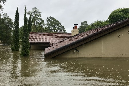 Exterior of house surrounded by water up to the roof