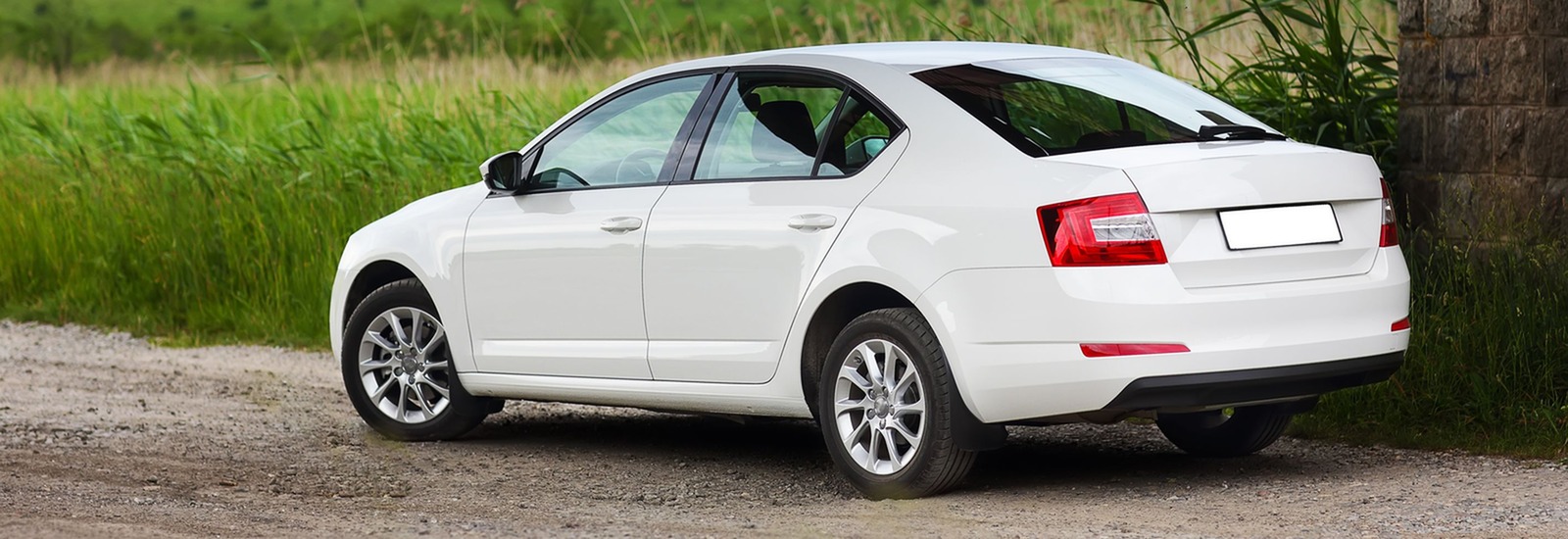 White car on dirt road